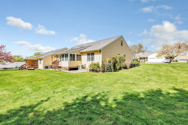 rear view of property featuring a yard