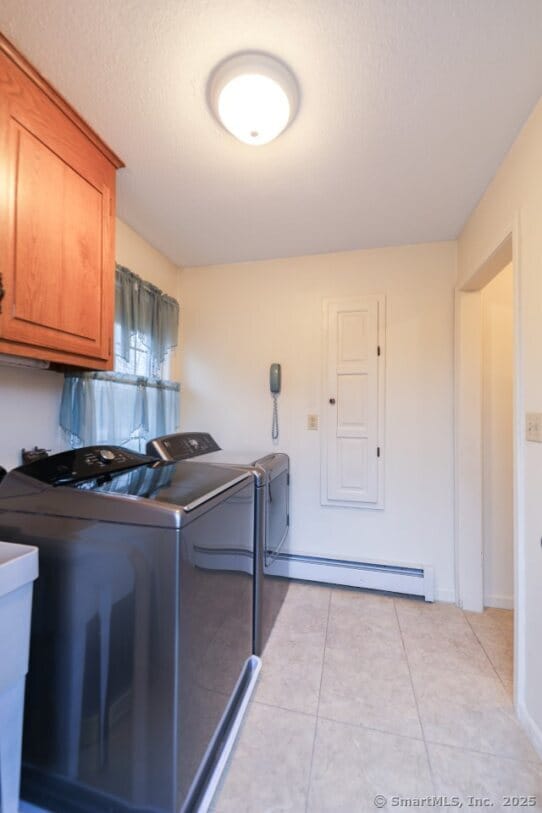 1900 Litchfield Rd, Watertown, CT 06795 - washroom featuring a baseboard heating unit, cabinet space, independent washer and dryer, and light tile patterned flooring