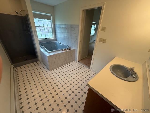 1900 Litchfield Rd, Watertown, CT 06795 - bathroom with a stall shower, a bath, vanity, and tile patterned flooring