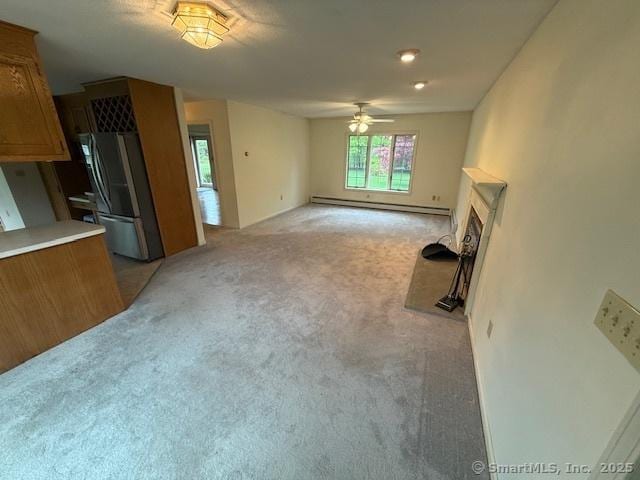 1900 Litchfield Rd, Watertown, CT 06795 - unfurnished living room featuring a baseboard radiator, light colored carpet, ceiling fan, and a fireplace