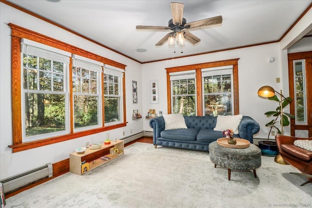 living area featuring a baseboard radiator, crown molding, a healthy amount of sunlight, and ceiling fan