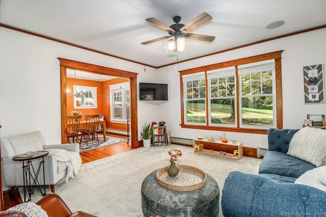 carpeted living room featuring ornamental molding and baseboard heating