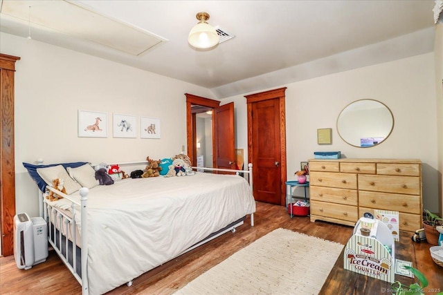 bedroom with wood finished floors