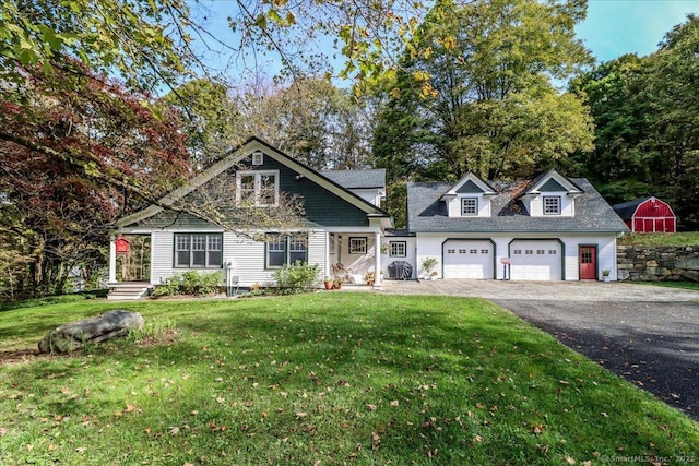 view of front of home with a front yard, driveway, and a garage