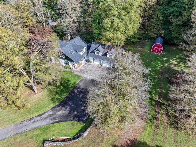 birds eye view of property with a wooded view