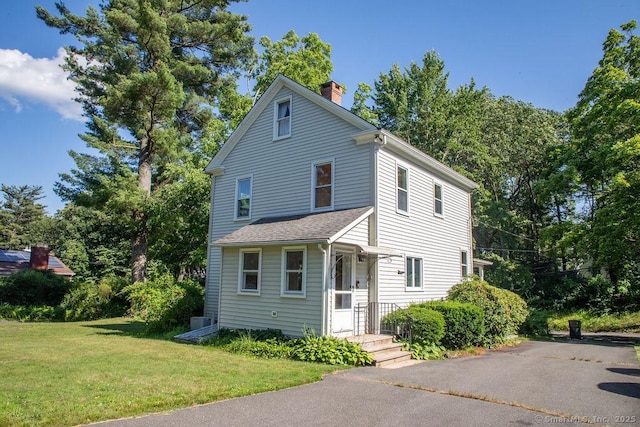 26 Seminary Rd, Simsbury, CT 06070 - view of front of property featuring a chimney, a front lawn, and a shingled roof