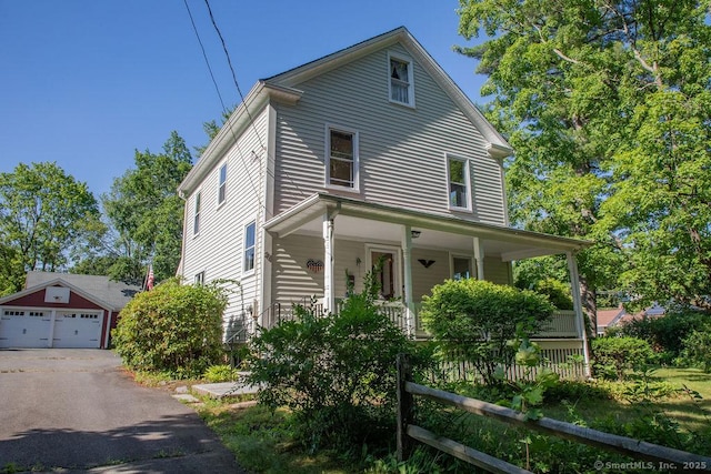 26 Seminary Rd, Simsbury, CT 06070 - view of front of house with a porch, a detached garage, and an outbuilding
