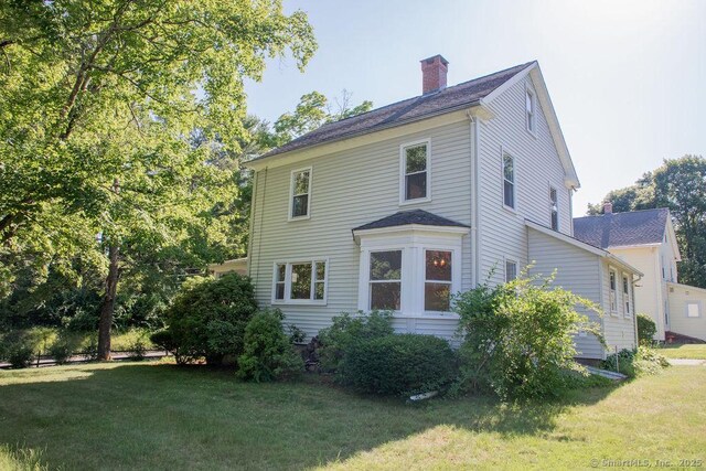 26 Seminary Rd, Simsbury, CT 06070 - view of front facade with a chimney and a front lawn