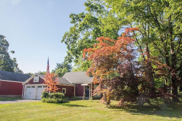 26 Seminary Rd, Simsbury, CT 06070 - view of front of home featuring a garage, a front yard, and asphalt driveway