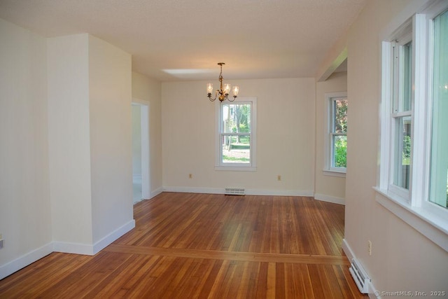 26 Seminary Rd, Simsbury, CT 06070 - unfurnished room featuring wood-type flooring, a chandelier, and baseboard heating