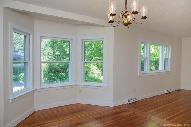 26 Seminary Rd, Simsbury, CT 06070 - unfurnished dining area with healthy amount of natural light, a chandelier, and wood finished floors