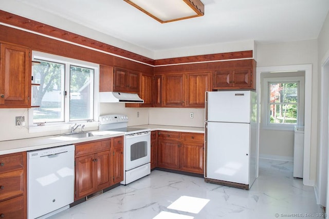26 Seminary Rd, Simsbury, CT 06070 - kitchen featuring white appliances, under cabinet range hood, light marble finish floors, light countertops, and brown cabinets