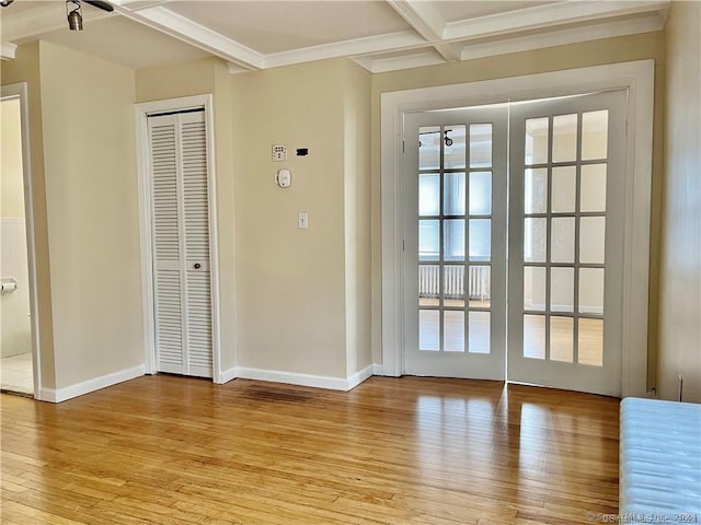entryway with light wood-style flooring, beam ceiling, baseboards, and coffered ceiling