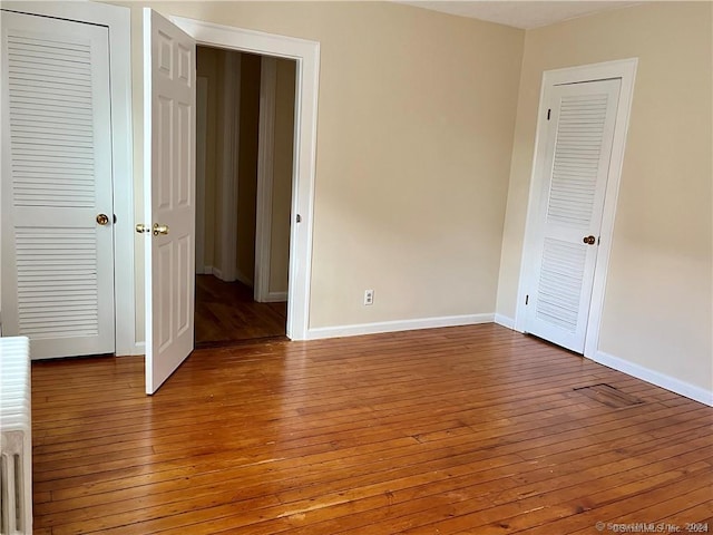 unfurnished bedroom with baseboards and light wood-style floors
