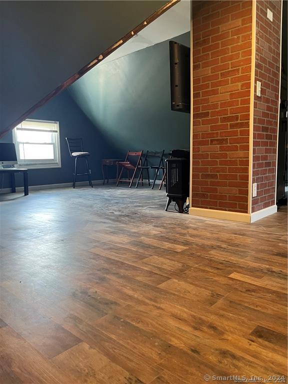 bonus room featuring lofted ceiling and wood finished floors