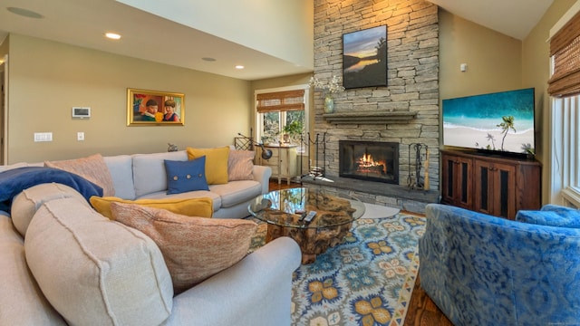 224 Tepi Dr, Southbury, CT 06488 - living room featuring recessed lighting, lofted ceiling, a stone fireplace, and wood finished floors