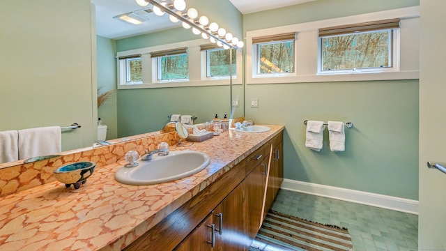 224 Tepi Dr, Southbury, CT 06488 - bathroom with double vanity, toilet, baseboards, and a sink