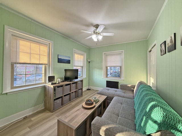 2811 Fairfield Ave Unit 1, Bridgeport, CT 06605 - living area with radiator heating unit, crown molding, light wood-type flooring, ceiling fan, and baseboards