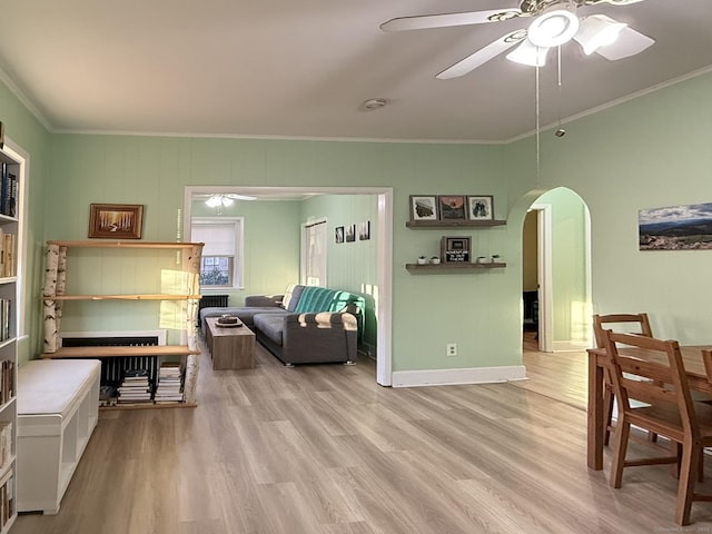 2811 Fairfield Ave Unit 1, Bridgeport, CT 06605 - living room featuring arched walkways, ornamental molding, ceiling fan, wood finished floors, and baseboards
