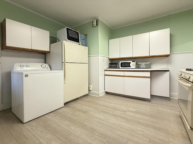 2811 Fairfield Ave Unit 1, Bridgeport, CT 06605 - kitchen with washer / dryer, white appliances, ornamental molding, white cabinets, and a wainscoted wall