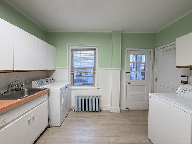 2811 Fairfield Ave Unit 1, Bridgeport, CT 06605 - laundry room featuring radiator heating unit, separate washer and dryer, light wood finished floors, plenty of natural light, and ornamental molding