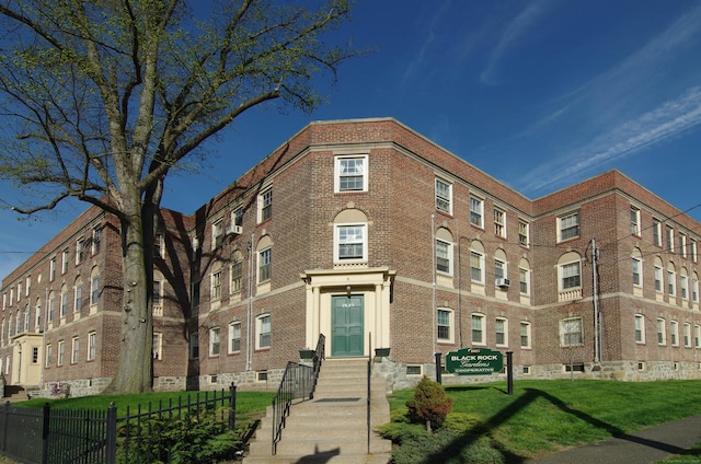 2811 Fairfield Ave Unit 1, Bridgeport, CT 06605 - view of building exterior featuring fence and entry steps