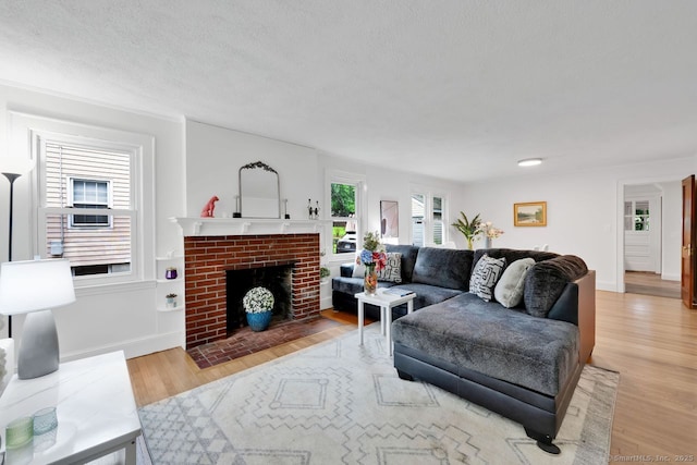 134 Saint Charles St, West Hartford, CT 06119 - living area with light wood-type flooring, a fireplace, and baseboards