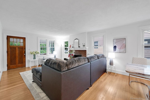 134 Saint Charles St, West Hartford, CT 06119 - living area with light wood-style flooring, a fireplace, and baseboards