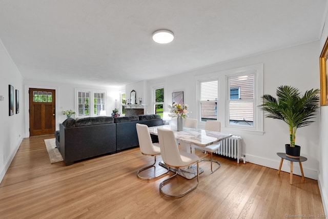 134 Saint Charles St, West Hartford, CT 06119 - dining space featuring radiator heating unit, light wood-type flooring, and baseboards