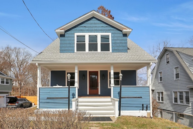 bungalow-style house featuring covered porch and roof with shingles