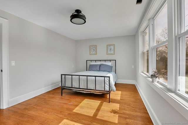 bedroom with baseboards and light wood-style floors