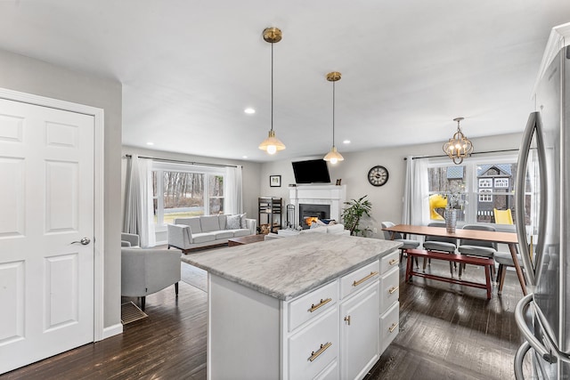 21 White Birch Rd, Redding, CT 06896 - kitchen featuring a lit fireplace, freestanding refrigerator, white cabinetry, and dark wood-type flooring