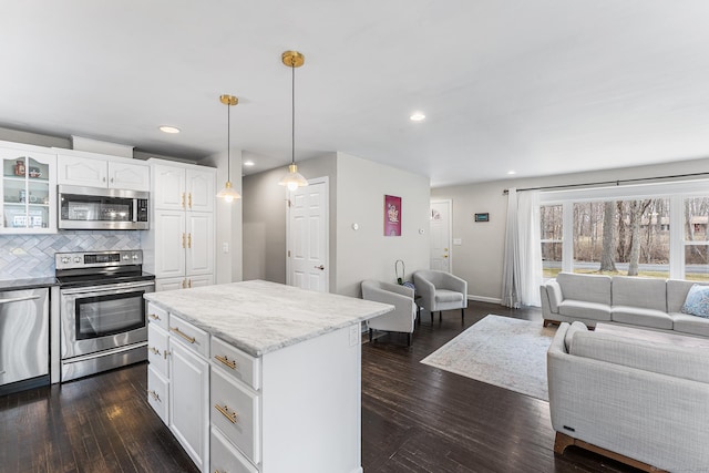 21 White Birch Rd, Redding, CT 06896 - kitchen featuring a center island, glass insert cabinets, open floor plan, stainless steel appliances, and white cabinets