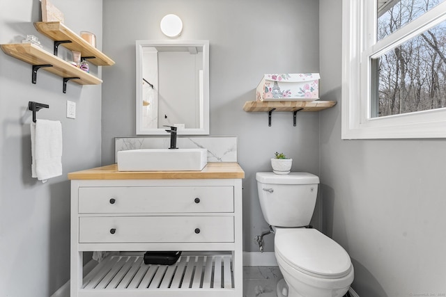 21 White Birch Rd, Redding, CT 06896 - bathroom featuring vanity, toilet, baseboards, and marble finish floor