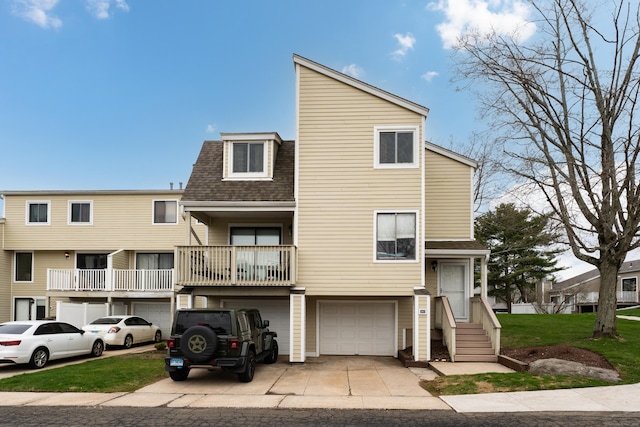 multi unit property featuring an attached garage, driveway, and roof with shingles