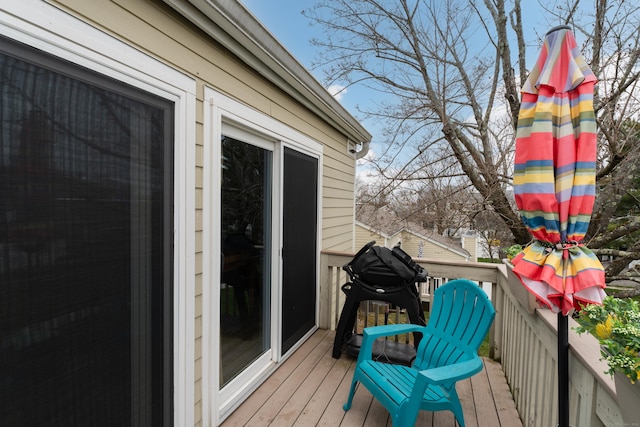 wooden deck with a grill