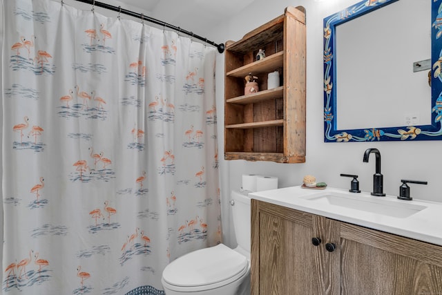 bathroom featuring toilet, a shower with shower curtain, and vanity