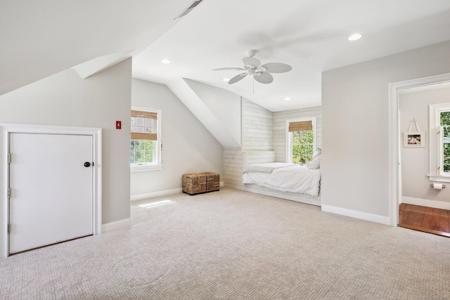 carpeted bedroom featuring baseboards, recessed lighting, and lofted ceiling
