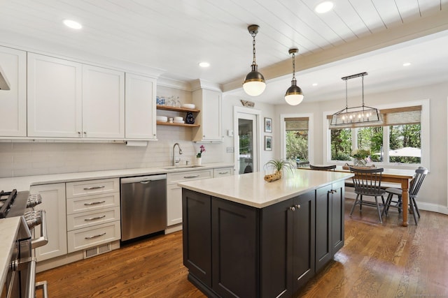kitchen featuring tasteful backsplash, a sink, light countertops, stainless steel appliances, and white cabinetry