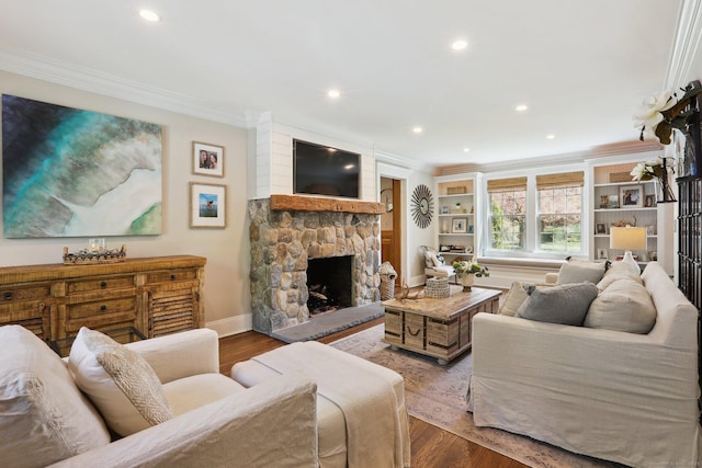 living room with ornamental molding, a fireplace, recessed lighting, and wood finished floors