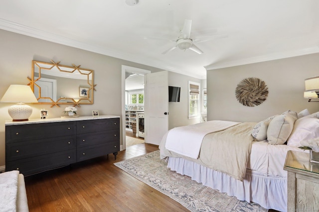 bedroom with crown molding, a ceiling fan, and dark wood-type flooring