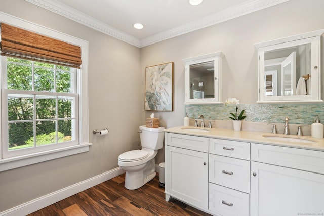 full bath with a sink, toilet, and a wealth of natural light