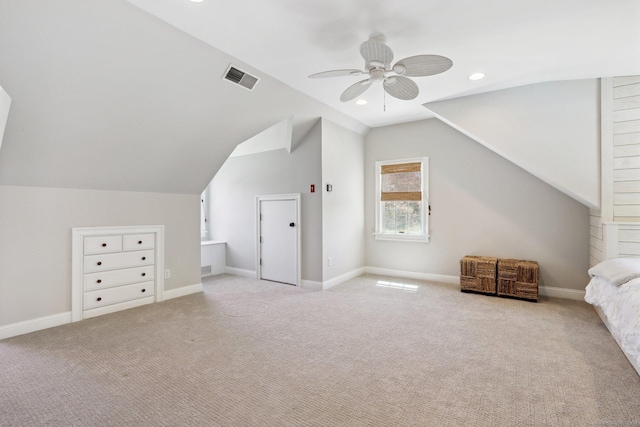 additional living space with carpet floors, ceiling fan, visible vents, and lofted ceiling