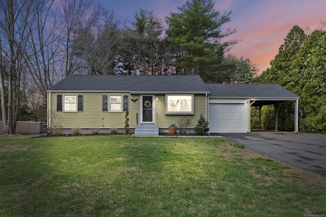 ranch-style home featuring a carport, driveway, a front lawn, entry steps, and a garage