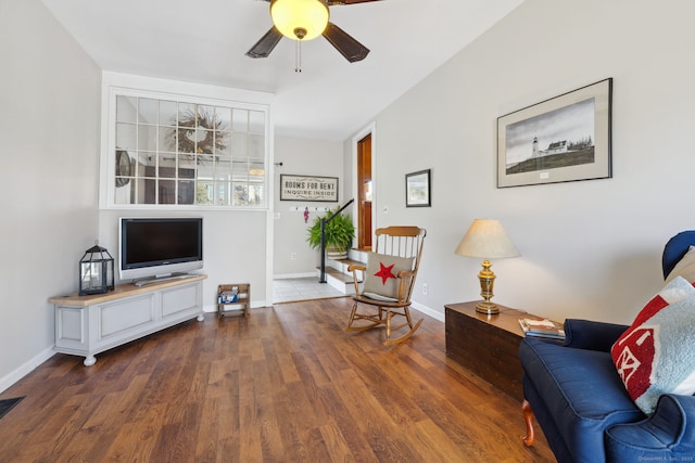 living area with a ceiling fan, baseboards, visible vents, and wood finished floors