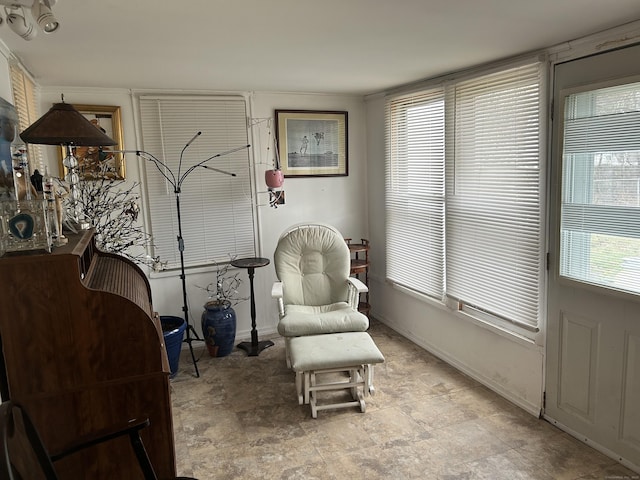 living area featuring baseboards