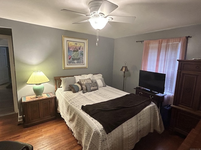 bedroom with light wood finished floors and a ceiling fan