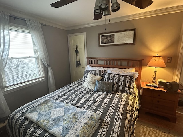 bedroom featuring wood finished floors, ceiling fan, and ornamental molding