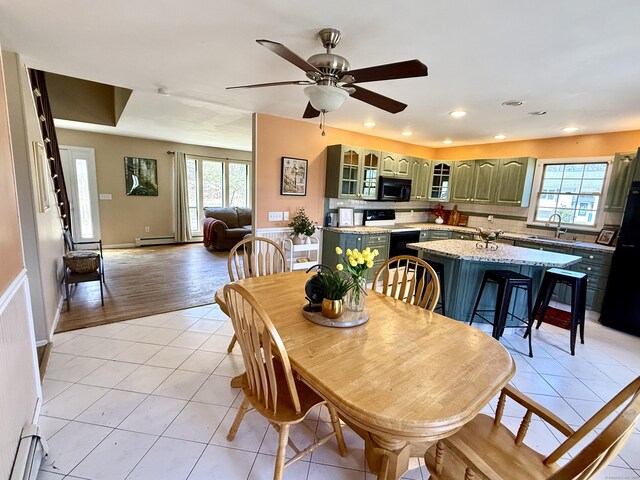 dining space featuring light tile patterned flooring, a baseboard heating unit, baseboards, ceiling fan, and recessed lighting