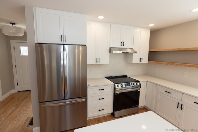 58 Killingworth Tpke, Clinton, CT 06413 - kitchen with light countertops, appliances with stainless steel finishes, under cabinet range hood, white cabinetry, and open shelves